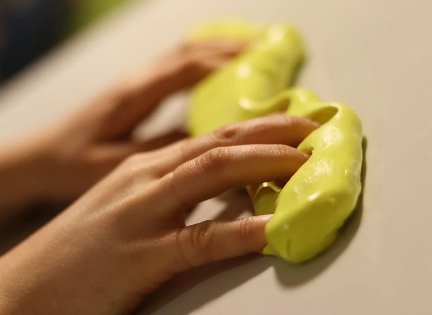 Kinderhände kneten gelbe Therapieknete
